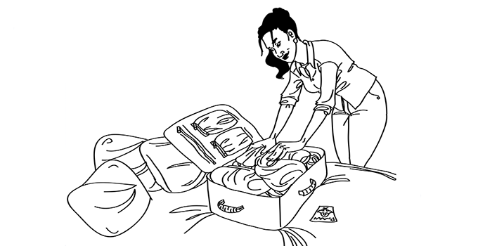 woman in her twenties packing a suitcase
