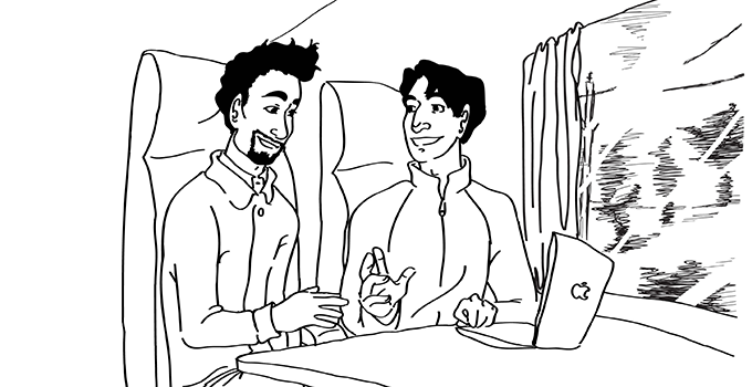 Tony and Denis on a train with laptop in front of them